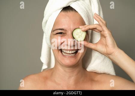 Happy mature woman having skin care spa day - People wellness lifestyle concept Stock Photo