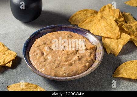 Homemade Refried Baked Bean Dip with Cheese and Chips Stock Photo