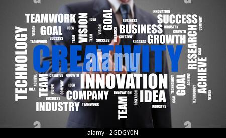 Creativity word cloud concept shown by a businessman in background Stock Photo