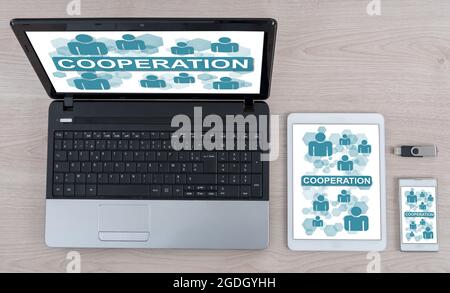 Cooperation concept shown on different information technology devices Stock Photo