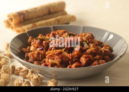 Dry roasted soya chunks with onions tomatoes and spices. Prepared with Kerala style meat masala in coconut oil. Served with indian flatbread. Shot on Stock Photo