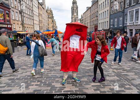 Edinburgh, Scotland, UK. 13th August  2021. Performers from the UCL Graters theatre group promote their Post Office themed show Post Humour on the Royal Mile today.  Iain Masterton/Alamy Live news. Stock Photo