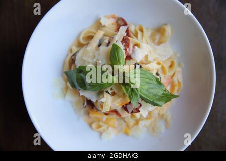 Chorizo sausage spaghetti fettuccine on wood background Stock Photo