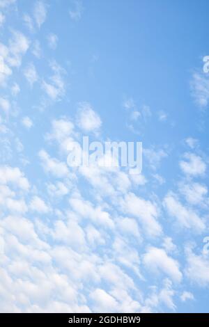 Sky with white small clouds. Cloudscape, vertical background with space for your own text Stock Photo