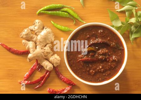 Ginger curry is a dark brown sweet-sour and spicy Keralite curry made of ginger, tamarind, green chillies and jaggery. It is also known as Injipuli or Stock Photo