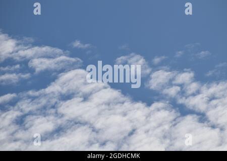 Fluffy white clouds in a blue sky Stock Photo