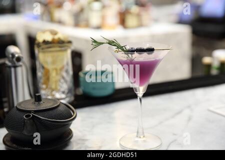 Purple cocktail on bar background Stock Photo