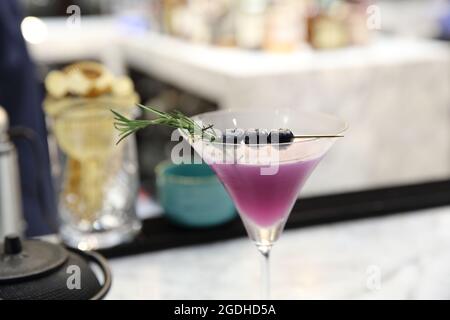 Purple cocktail on bar background Stock Photo