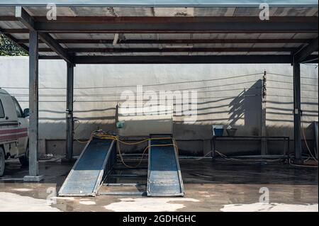 Front of empty car wash or car care with track car ramp in station Stock Photo