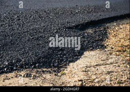 New asphalt tarmac texture road of repairing on the damaged highway in construction site Stock Photo