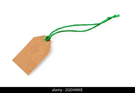 Blank cardboard tag on a green jute ribbon isolated on white background. Empty brown paper label with flax twine close-up. Recyclable rope tag. Stock Photo