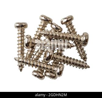 Pile of metal screws isolated on white background. Pan head screws macrophotography. Round screw with thread. Self-tapping screw. Tools and equipment. Stock Photo