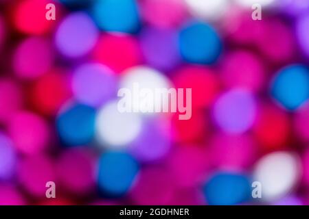 An abstact colorful blurry background of different colors. The bokeh balls are pink, red, purple, white and blue. Stock Photo