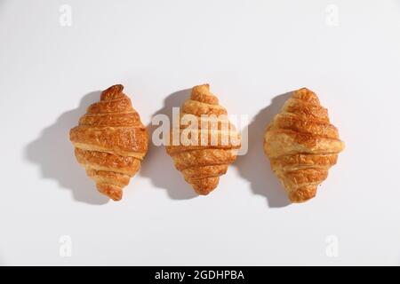 Croissant isolated in  wihite background with sunny light Stock Photo