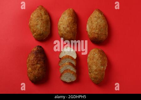 Tasty cutlets on red background, top view Stock Photo