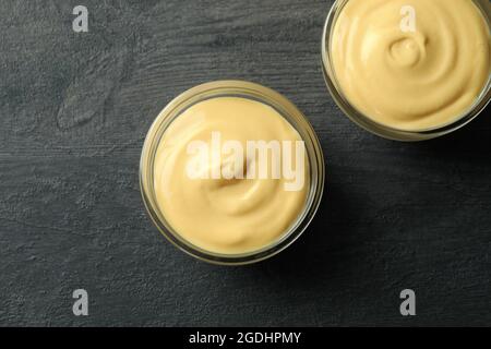 Bowls with cheese sauce on dark background Stock Photo