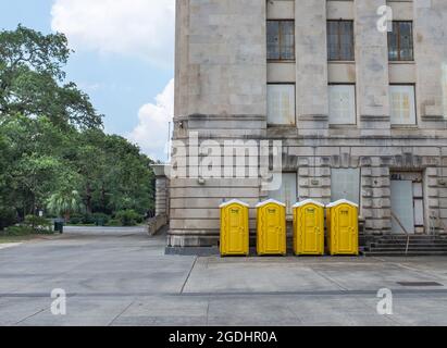 New Orleans, LA, USA - August 7, 2021: Four Yellow Pot-O-Gold portable toilets next to the Municipal Auditorium Stock Photo