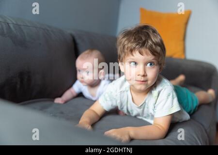 Two boys lying on the sofa Stock Photo