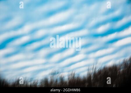 Blue morning sky filled with beautiful clouds during Spring Stock Photo