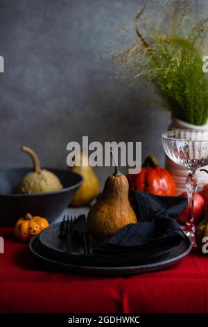 Festive table setting for holiday Thanksgiving dinner decorated with pumpkin Stock Photo