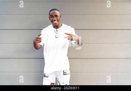 portrait of young man of color smiling at camera Stock Photo