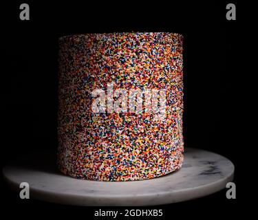 rainbow sprinkle cake on white marble Stock Photo
