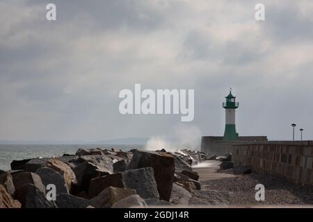 The surf hits the pier light of Sassnitz. Stock Photo