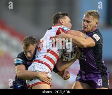 Keanan Brand (24) of Leigh Centurions is tackled by Brad Dwyer (14) of Leeds Rhinos and Jarrod O'Connor (26) of Leeds Rhinos Stock Photo