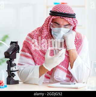 The arab doctor chemist studying new virus in lab Stock Photo