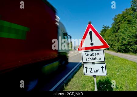 sign 'Caution 2 km of Road Damage' on the roadside , Germany Stock ...