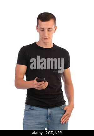 Young man reading his messages on his phone on a white background Stock Photo