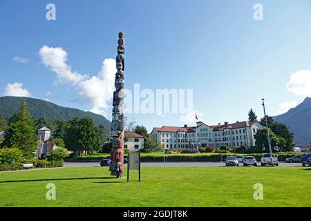 Sitka, Alaska. A view of the Baranof Totem Pole, in Totem Square and in front of the Sitka Pioneer’s Home. Stock Photo