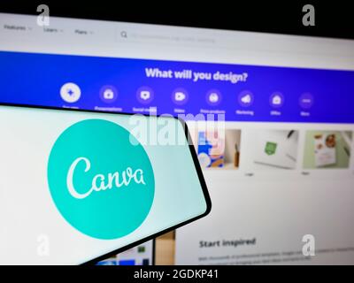 Smartphone with logo of Australian graphic design company Canva Pty Ltd on screen in front of website. Focus on center-right of phone display. Stock Photo