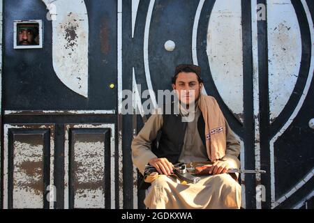 Herat, Afghanistan. 14th Aug, 2021. A Taliban militant is seen in Herat province, Afghanistan, Aug. 13, 2021. The Afghan Taliban said their members overran three more provincial capitals on Friday, after they have taken control over a dozen cities within a week. Zabihullah Mujahid, a Taliban spokesman, wrote on his social media account that they captured Tirin Kot, capital of southern Uruzgan province, and Firoz Koah, capital of western Ghor province. Credit: Xinhua/Alamy Live News Stock Photo