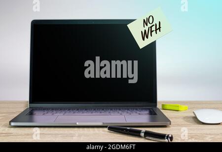 No WFH (Work from home) sticky note text on laptop Stock Photo
