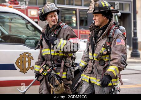 JESSE SPENCER and TAYLOR KINNEY in CHICAGO FIRE (2012), directed by MICHAEL BRANDT, STEVE SHILL and SANFORD BOOKSTAVER. Credit: Wolf Films / Universal Pictures Television / Album Stock Photo