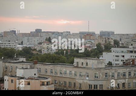 Bucharest, Romania - August 13, 2021: Overview of the old part of Bucharest during a summer sunset. New and old buildings together. Stock Photo