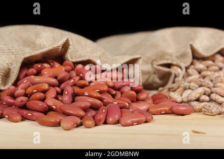 Brown paper bag full of a pile of raw red kidney beans Stock Photo by  wirestock