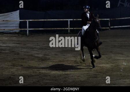 Gaza City, Gaza Strip, Palestine. 13th Aug, 2012. Gaza, Palestine. 13 August 2021. Male and female riders compete in the show-jumping championship at the Al Jawad Equestrian Club in Gaza City. The equestrian event has been organised by the Palestinian Equestrian Federation (Credit Image: © Ahmad Hasaballah/IMAGESLIVE via ZUMA Press Wire) Stock Photo