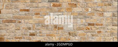 Old beige brown panoramic natural stone wall Stock Photo