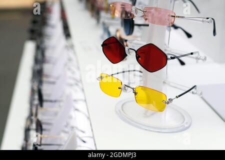 Sunglasses with colored lenses in shop window Stock Photo