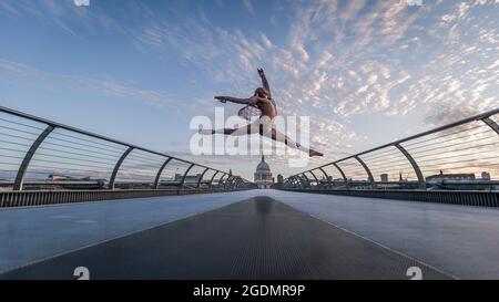 A ballet dancer on Millennium Bridge in London at sunrise. Stock Photo