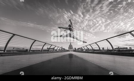 A black and white image of a ballet dancer on Millennium Bridge in London. Stock Photo