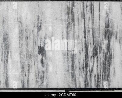 Top view of the old floor, made of various sized pieces of white and gray marble. Abstract black and white monochrome mosaic background. Stock Photo