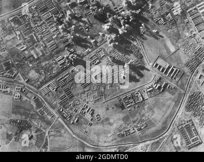 Bomb loads from Boeing B-29 Superfortresses of Major General Curtis E. LeMay's 20th Bomber Command plaster the Japanese arsenal at Mukden, Manchuria during World War II Stock Photo