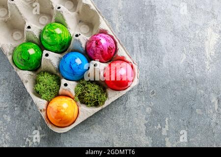 Paper box with Easter eggs on grey, stone background. Copy space. Stock Photo