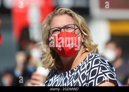 Bochum, Germany. 14th Aug, 2021. Svenja Schulze, (SPD) Federal Minister for the Environment, sits with a mouth guard with the inscription 'Team Olaf SPD' on Dr. Rur Platz in Bochum. SPD candidate for chancellor Scholz starts the hot phase of the election campaign in the Ruhr area. Around six weeks before the federal election, he is speaking in the city centre of Bochum to kick off his tour. Credit: David Young/dpa/Alamy Live News Stock Photo