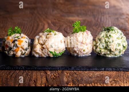 four different dumplings on slate Stock Photo