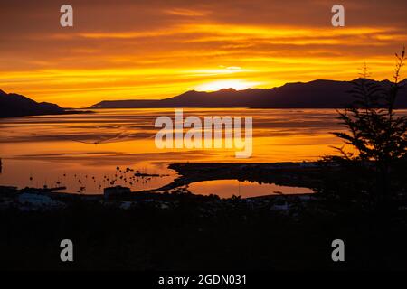 Sunset over the Bay of Ushuaia the southernmost city in the word and the capital of Tierra del Fuego, Antartida e Islas del Atlantico Sur Province, Ar Stock Photo