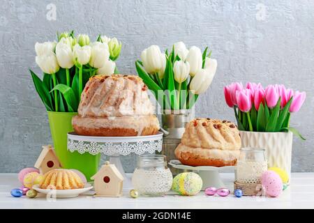 Easter table with cakes, eggs and flowers. Festive decor Stock Photo